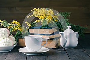 Cup of tea with book and sweets