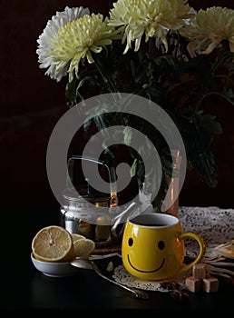 A cup of tea and a bouquet of chrysanthemums