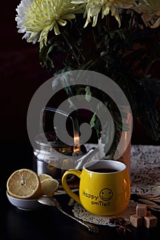 A cup of tea and a bouquet of chrysanthemums