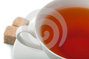 Cup of tea with brown sugar isolated