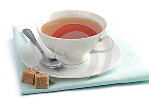 Cup of tea and brown sugar isolated