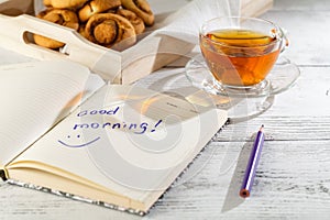 Cup of tea with cakes on wooden tray