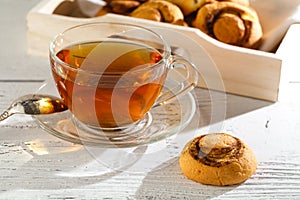 Cup of tea with cakes on wooden tray