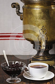 A cup of tea, a cherry jam and a samovar