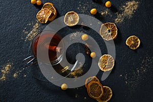 Cup of tea with cinnamon stick and fruits