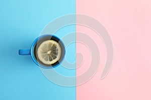Cup of tea on color background, top view