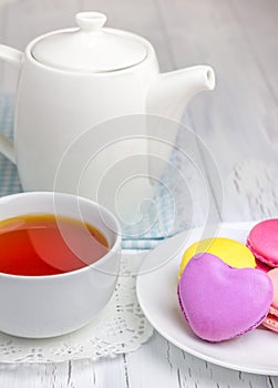 A cup of tea with colorful macarons