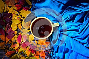 Cup of tea with colourful autumn leaves.