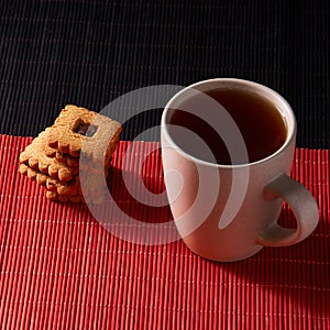 Cup of Tea with Cookies on style red and black background