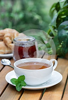 Cup of tea with fresh mint leaves