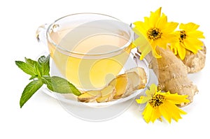 Cup of tea with ginger slices and Echinacea flower
