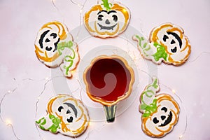 Cup of tea and Halloween homemade cookies top view. Creative trick or treat concept. Atmospheric autumn table