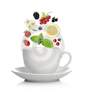 Cup of tea with herbs, fruits and berries