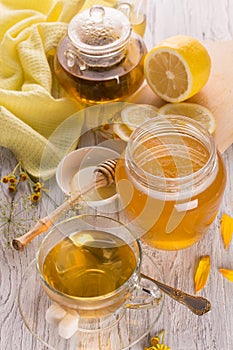 Cup of tea and honey in a glass jar