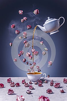 Cup of tea with kettle and roses