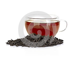 Cup of tea and leaves black tea isolated on white