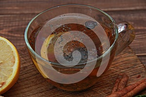 cup of tea with lemon close-up on a wooden table