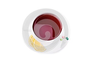 Cup of tea with lemon and pills