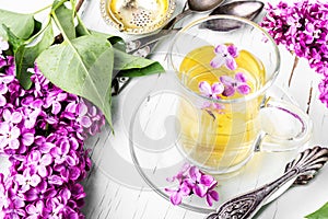 Cup of tea and lilac flowers