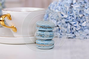 Cup of tea, macaroons and blue hydrangea