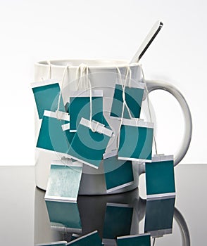 Cup of tea with many teabags photo