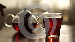 Cup of tea and mint on a wooden background