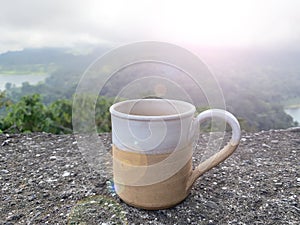 Cup of tea in the mountains. Relax on vacation with morning hot coffee or tea with nature view.