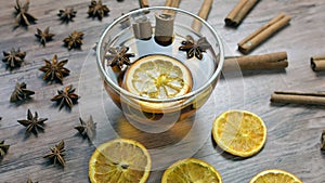 Cup tea with orange and cinnamon and anise on wooden background