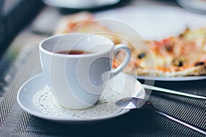 A cup of tea and pizza
