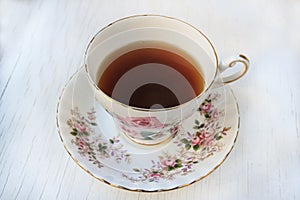 Cup of tea in a rose patterned china teacup and saucer