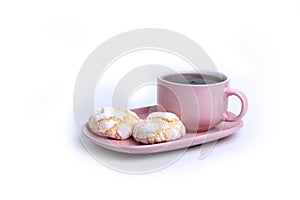 A cup of tea on a saucer and two pumpkin cookies  on white background