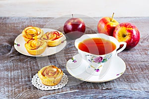 Cup of tea and small apple roses shaped pies