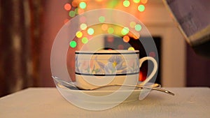 A Cup of tea with smoke on the background of bokeh. Christmas