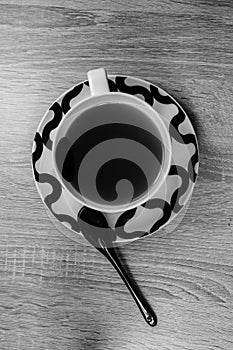 Cup of tea and spoon. Black and white