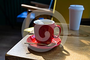 A cup of tea with a spoon on a wooden table