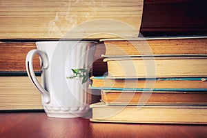 Cup of tea with stack of old books