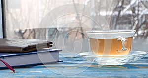 A cup of tea and sweets, on a blue wooden background