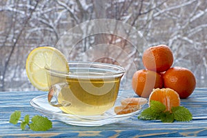 A cup of tea and sweets, on a blue wooden background