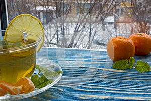 A cup of tea and sweets, on a blue wooden background