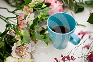 Cup of tea on the table, relax. Workshop florist, table with flowers, still life. Soft focus