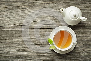 Cup of tea with tea pot