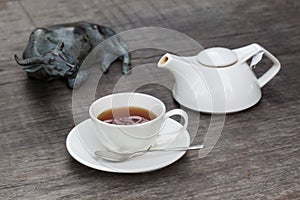 Cup of tea and tea's jar on old wooden