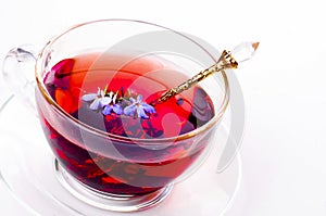 Cup of tea with teabag over white