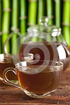 Cup of tea and teapot on nature background