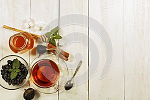 A cup of tea on a white table.Traditional Arabic, Turkish Ramadan tea with dry dates and raisins on a wooden white table. Turkish