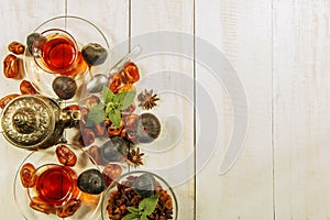 A cup of tea on a white table.Traditional Arabic, Turkish Ramadan tea with dry dates and raisins on a wooden white table. Turkish