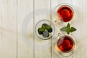 A cup of tea on a white table.Traditional Arabic, Turkish Ramadan tea with dry dates and raisins on a wooden white table. Turkish