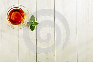 A cup of tea on a white table.Traditional Arabic, Turkish Ramadan tea with dry dates and raisins on a wooden white table. Turkish