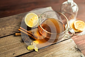 Cup of tea on wooden background with cinnamon, anise stars