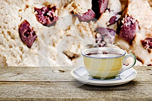 Cup of tea on wooden table chocolate cookie on background.